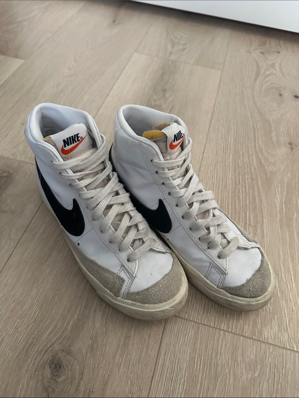 Nike White High-Top Sneakers with Black Swoosh